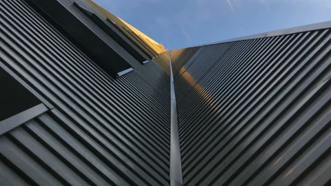 A siding grey surface of a modern building against a blue sky 库存影片 93597513