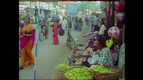 Sidwalk fruit vendor greets customers - India Stock Footage 240051378
