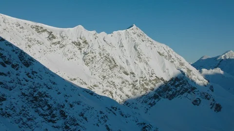 Sidways moving a large and snow covered mountain in the italian alps Stock Footage 102185757