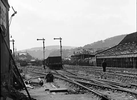 SIEGEN, GERMANY - 1945: Rail yard ruins - Gutted goods shed and buckled tracks Stock Footage 344488771