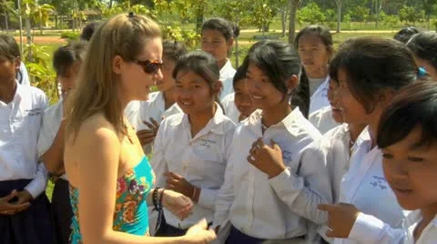 Siem reap cambodia school children in high school taking with tourist woman i Stock Footage