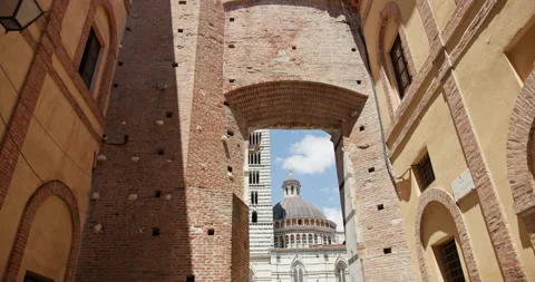 Siena cathedral framed by ancient archway in tuscany Видео 340588607