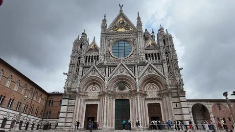 Siena Cathedral front view with cloudy sky, Tuscany, Italy Stock Photos
