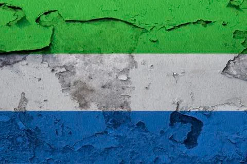 Sierra Leone flag painted on the cracked concrete wall Stock Photos