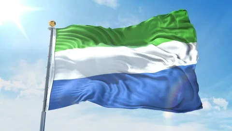 Sierra Leone flag waving in the wind against deep blue sky. National theme. Stock Footage 123985848