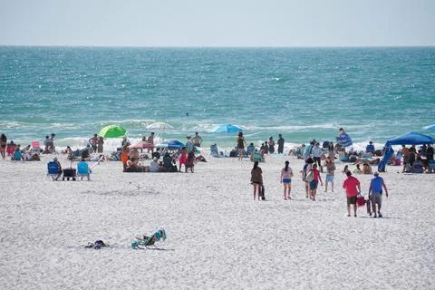 Siesta Key Beach, Florida, U.S - Jan 3, 2026 - Sunbathers and colorful umbr.. Stock Photos