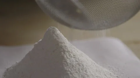 Sieving flour onto paper; close-up Stock Footage 64028236