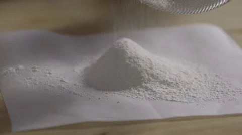 Sieving flour onto paper Stock Footage 64027840