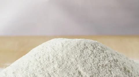 Sieving flour onto a worksurface Stock Footage 24663265