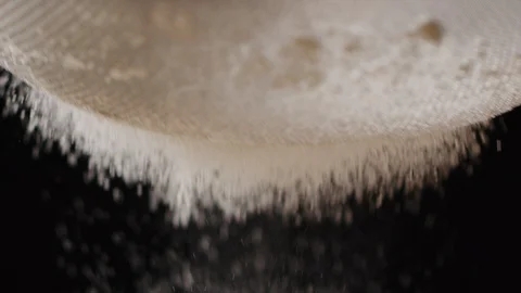 Sieving sugar powder macro shot Stock Footage 128492849