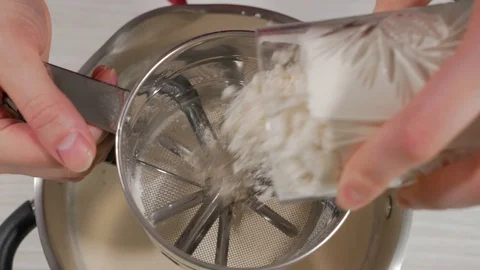 Sift flour through a sieve, close up Stock Footage 128667402