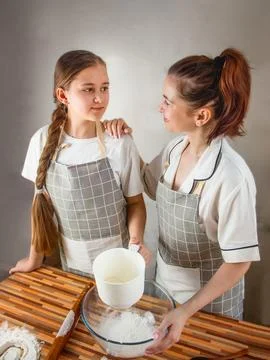 Sift flour through a sieve in the kitchen Stock Photos