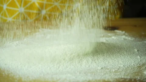 Sifted flour falls on the board. Close up. The sieve is not visible Stock Footage 220219757