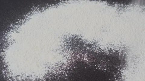 The sifted flour falls on the surface of the table. Stock Footage 248627306
