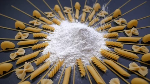 Sifted Flour Falls on Table with different type of pasta. Stock Footage 119723495