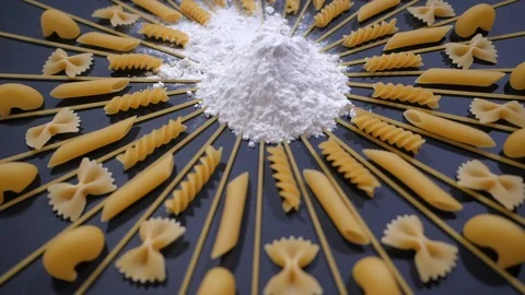 Sifted Flour Falls on Table with different type of pasta. Stock Footage 119725461