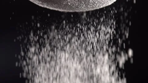 Sifting Flour on Black Background in Slow Motion Stock Footage 201237056