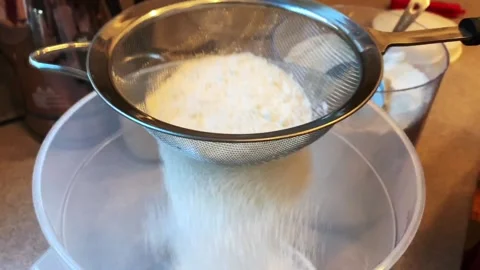Sifting Flour into a Bucket to Bake Bread at Home Stock Footage 134183420