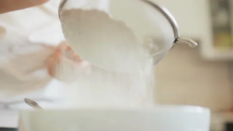 Sifting flour into a Cup through a sieve Video stock 88520780