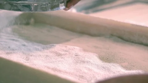 Sifting flour with flour filter. Making cookies. Woman hands sifting flour Stock Footage 84394719