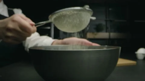 Sifting flour in the kitchen Stock Footage 141890036
