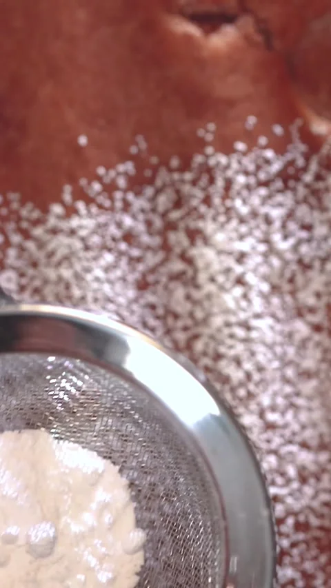Sifting flour in the kitchen for the perfect baking recipe every home cook Stock Footage 316860055