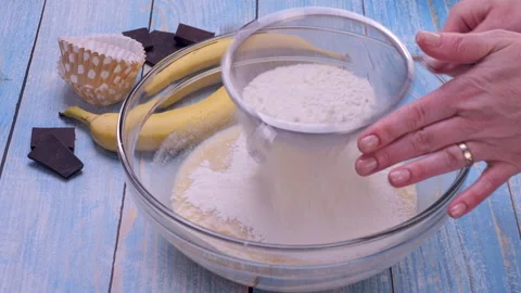Sifting Flour Over Dough in Close-Up 스톡 동영상 322926679