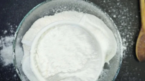 Sifting flour overhead Stock Footage 121119317