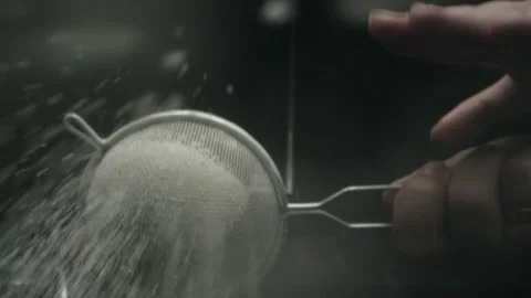 Sifting flour with a sieve in the kitchen Stock Footage 141890101