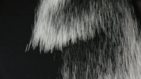 Sifting flour through sieve. Black background. Slow motion. Stock Footage 127797012