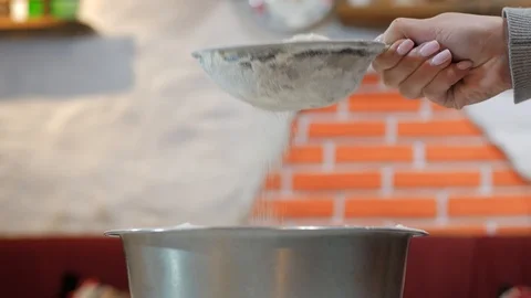 Sifting flour through sieve Stock-Footage 95831248