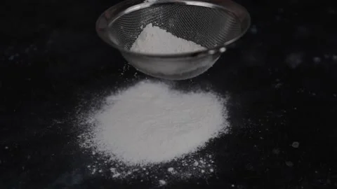 Sifting flour through sieve Stock Footage 154984960