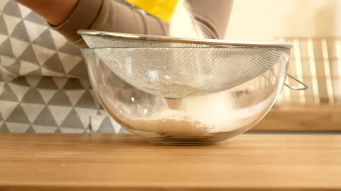Sifting flour through a sieve Stock Footage 196860722