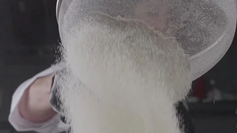 Sifting flour through a sieve. Stock Footage 313973082