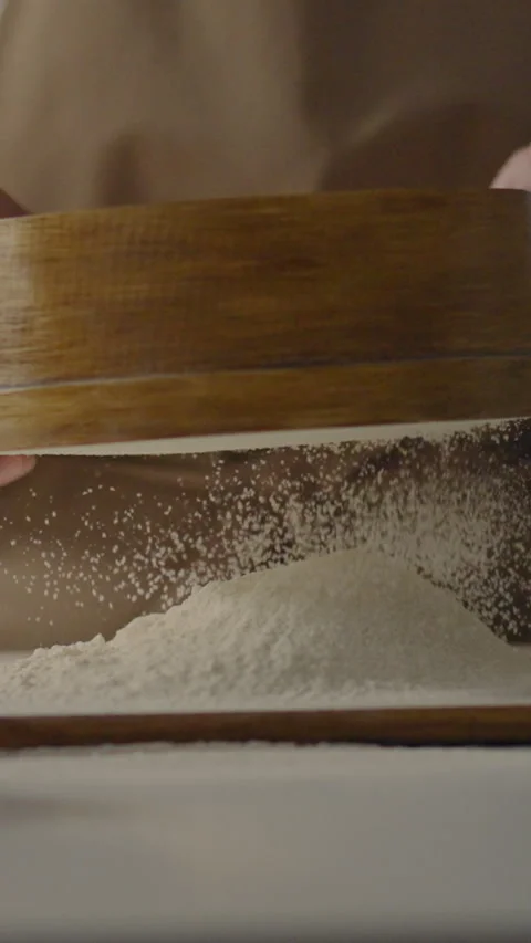 Sifting flour in a traditional kitchen for baking fresh bread at home Stock Footage 331726501