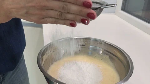 Sifting Flour While Adding it to a Bowl with a Dough - Slow Motion Footage Stock Footage 123540008
