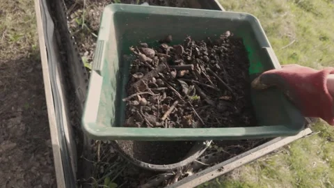 Sifting fresh compost. Separation soil and yet uncomposted parts. Stock Footage 271028899