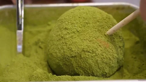 Sifting Green Matcha Powder Over Apple on Stick for Dessert Coating Stock Footage 345292688