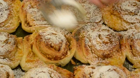 Sifting icing sugar onto buns Stock Footage 45015130