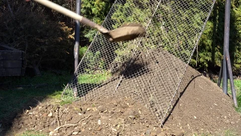 Sifting soil through a sieve to remove lumps and stones Stock Footage 126320901