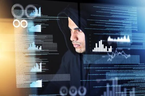 Sifting through the data. Shot of a young hacker cracking a computer code in  Stock-Fotos