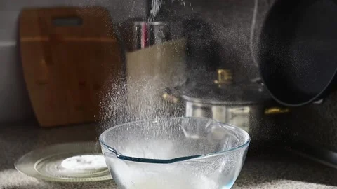 Sifting white flour, close up, slow motion. Making homemade bread. Video stock 165851365