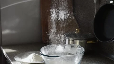 Sifting white flour, close up, slow motion. Making homemade bread. Video stock 165851441