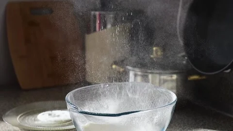 Sifting white flour, close up, slow motion. Video stock 169577239