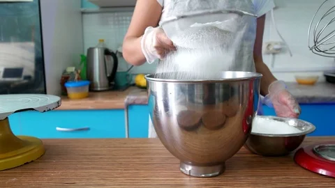 Sifts the flour through a sieve Stock Footage 75509937