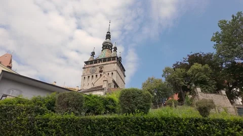 Sighisoara Clock Tower rising above gardens in the medieval Old Town of Stock Footage 346520391