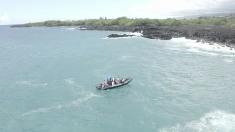 Sight-seeing boat viewing waves crash on cliffs and rocks. 4k Drone Stock Footage 124441744