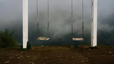 The sight of Svaneti - swing in mountains. Empty swing against foggy mountains Stock Photos