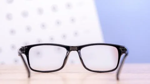 Sight test seen through eye glasses, white background Stock Photos