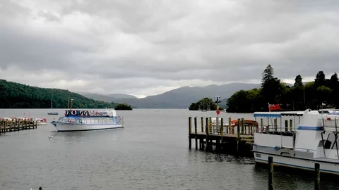 Sightseeing boat backs from dock-Bowness Bay-Lake Windermere England Stock Footage 96213192